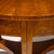 Round Biedermeier table on three legs with a trefoil center board and smooth frame. The tabletop is radially veneered and...