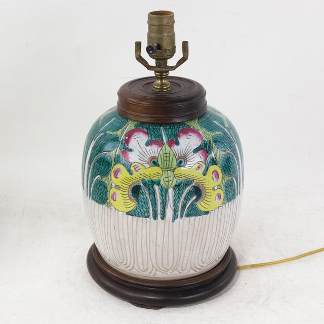 This antique table lamp is expertly crafted from an authentic porcelain vessel featuring the traditional and highly...