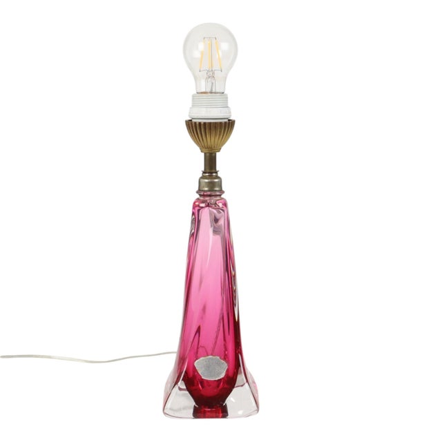 A stunning hand-blown table lamp made of purple and pink crystal; it features a striking, twisted blown-glass form and a...