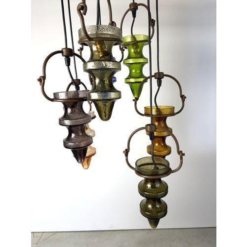 Striking brutalist chandelier designed by Nanny Still and produced by Massive, Belgium. it consists of 7 glass lamp...