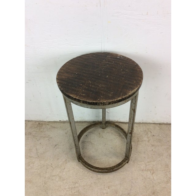 This mid century modern industrial style stool features newer wood top and gray painted metal base.