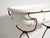 This antique bathtub in enamelled iron rests on a folding stand of bent iron tube. Originates from Central Europe, from...