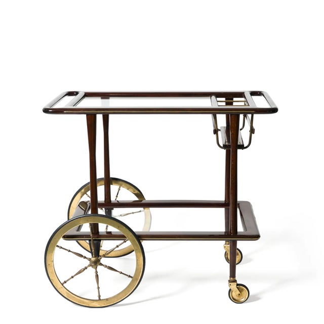 1950s Italian bar cart by Cesare Lacca. Mid-century chic, modern style and pure elegance in wood with brass detail and...