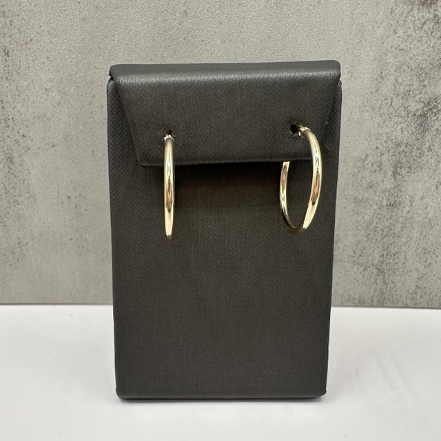These tube hoop earrings are crafted in 14kt yellow gold and feature a classic polished finish. With a 2.1mm width and...
