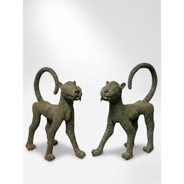 This striking pair of vintage cast bronze leopards features a bold, stylized design inspired by classic West African Benin...