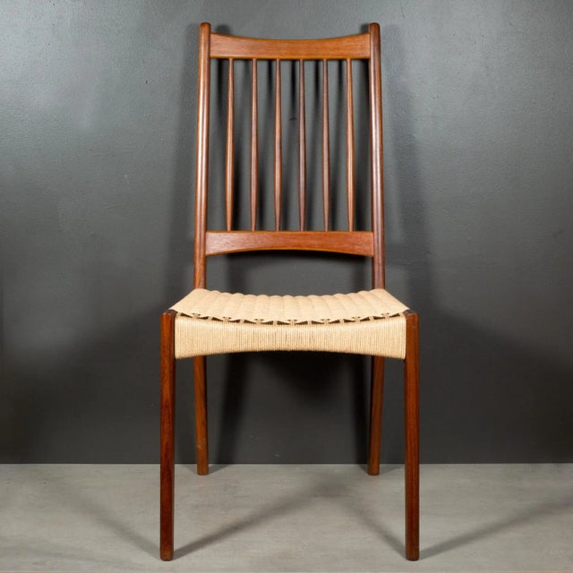 ABOUT A set of six mid-century rail back Teak and Danish paper cord dining chairs designed by Arne Hovmand-Olsen and...
