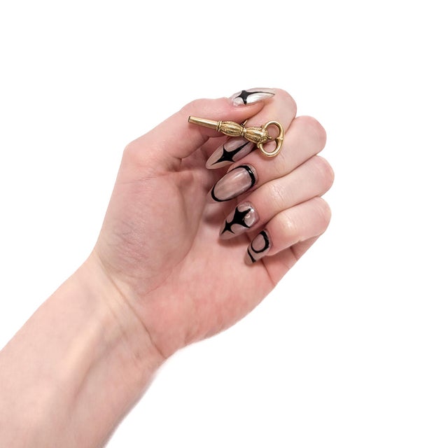 A fine antique gold key for a pocket watch. In 14 karat yellow gold. For the winding of a pocket watch. With an integral...