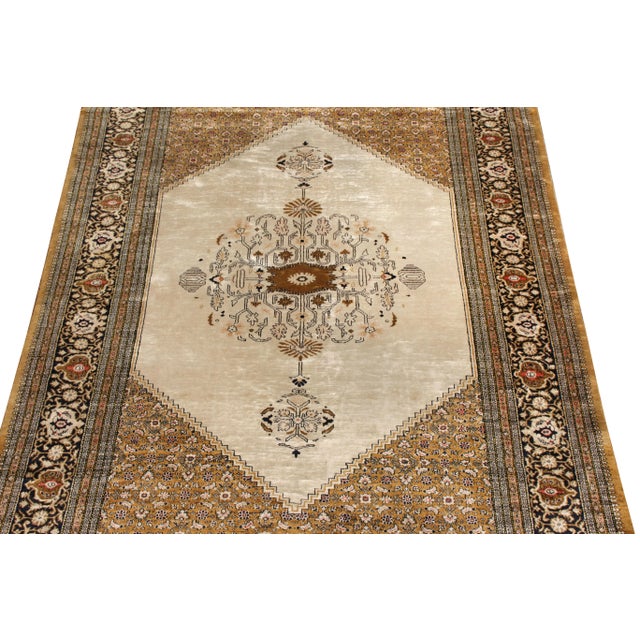 Originating from Persia circa 1950-1960, this vintage Persian rug is a distinct piece of its Qum design lineage with...