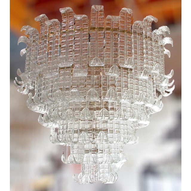 Italian chandelier shown with six tiers of clear hand blown Murano Felci fern glasses mounted on bronzed finish metal...
