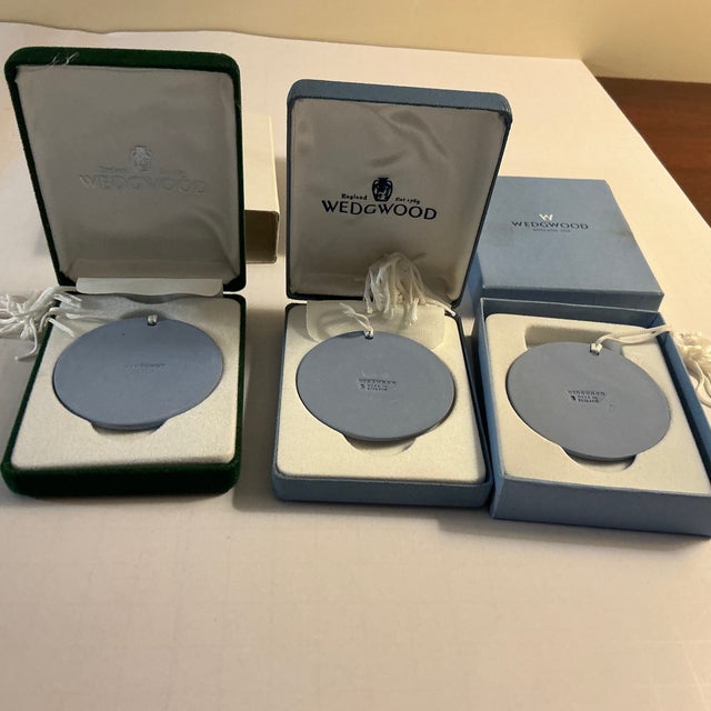 Set of three Wedgewood Jasperware disc ornaments in white on pale blue: Rocking Horse (1995), Lantern (1998) and Baubles...