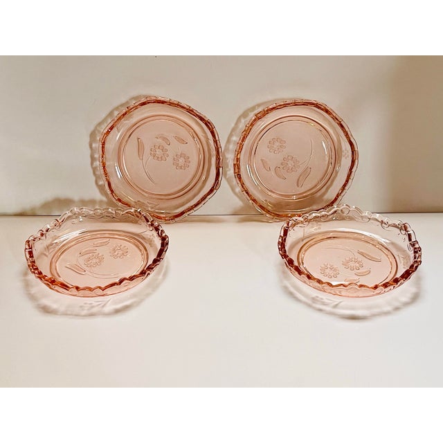 A charming set of scallop edged dessert dishes with a floral center made by Rosalin glass in the early 20th century.