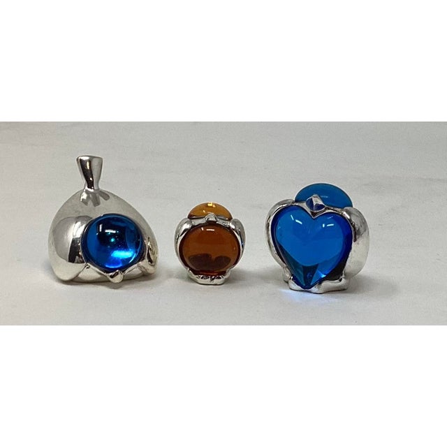A collection of a set of (3) miniature silverplate and glass paperweights from the "Lumierre" collection. Discountinued in...
