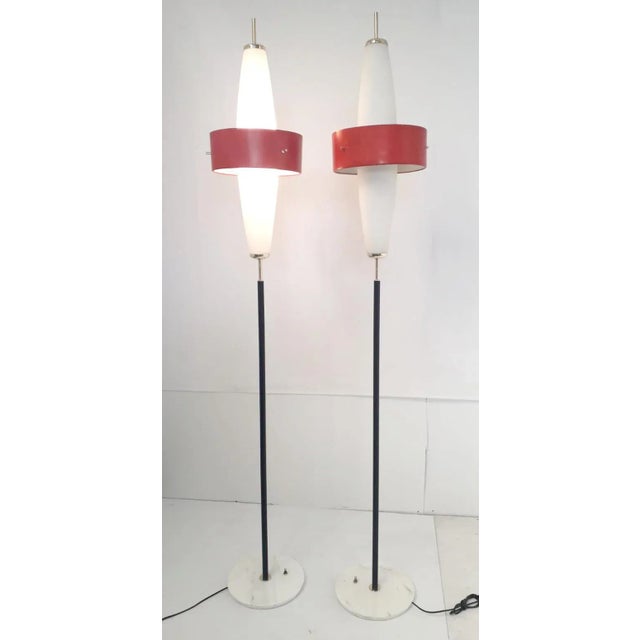 Rare pair of vintage Italian torchère floor lamps with frosted glass shades and red enameled metal bands, mounted on...