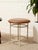 A charming vintage stool with a slender white metal frame designed to mimic the segmented look of bamboo. The rounded...