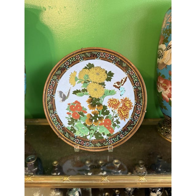 A finely executed Japanese cloisonné enamel plate measuring 12 inches in diameter, distinguished by its exceptional level...