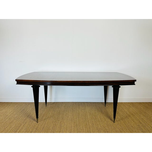 A superb art deco modernist table from the 1940s, featuring an elegant top in exotic wood veneer (macassar ebony),...