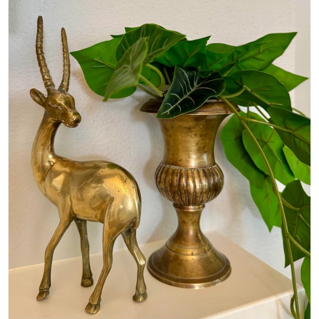 Elevate your space with this striking vintage brass antelope sculpture. Sleek lines and warm golden tones make it a...