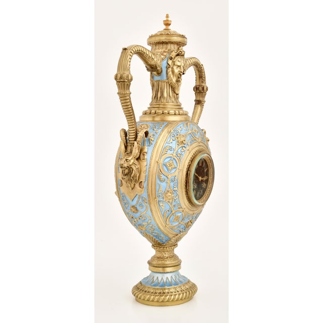 An exceptional Antique French gilt bronze and enamel porcelain urn-form clock, dating to the early to mid-19th century....