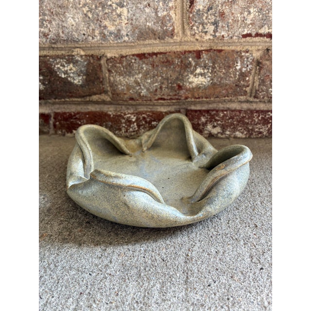 Vintage ceramic decorative dish featuring a unique folded rim with a soft grayish / green matte glaze. This piece would...