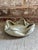 Vintage ceramic decorative dish featuring a unique folded rim with a soft grayish / green matte glaze. This piece would...