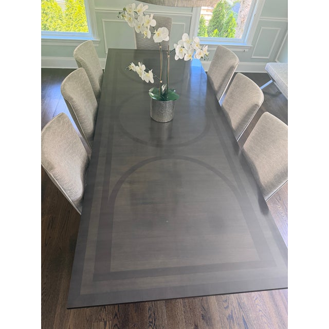 A custom-ordered Kravet dining suite of exceptional scale and craftsmanship, this set pairs the Kravet "Urn" dining table...