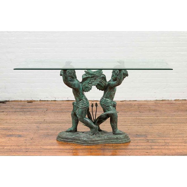 A Greco-Roman style contemporary bronze double cherub dining table base with Verde patina. The top is not included but...