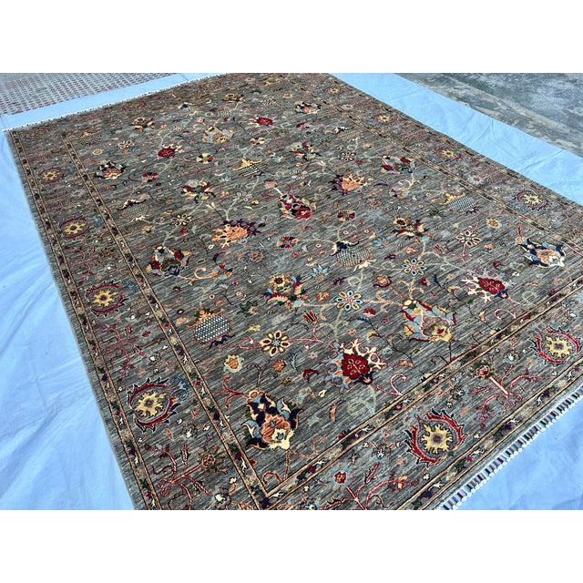 This exquisite hand-knotted wool area rug features a classic Afghan Sultanabad design with a beautiful Chobi styling. The...