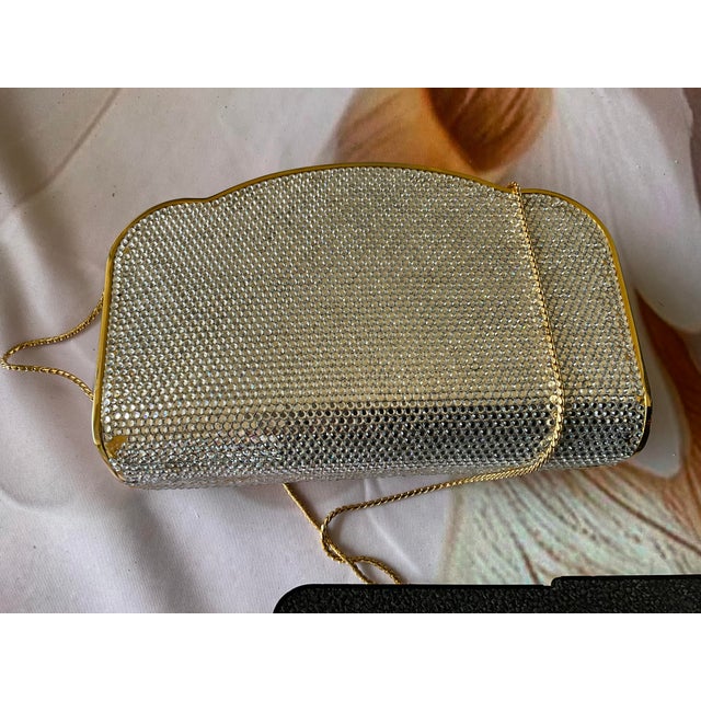 Judith Lieber minaudière clutch bag/crossbody. This clutch has sparkling rhinestones that can’t help but catch your eye....