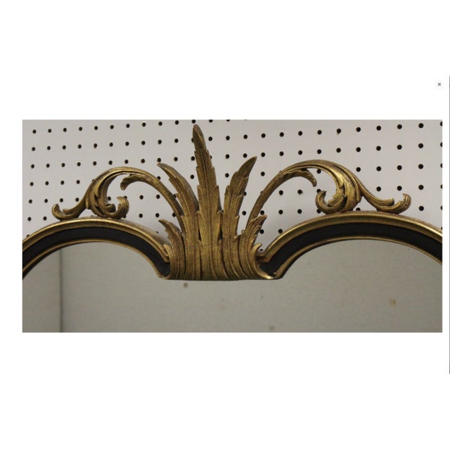 A vintage classically-designed black lacquer and gilded gold frame rectangular wall mirror with straight vertical sides,...