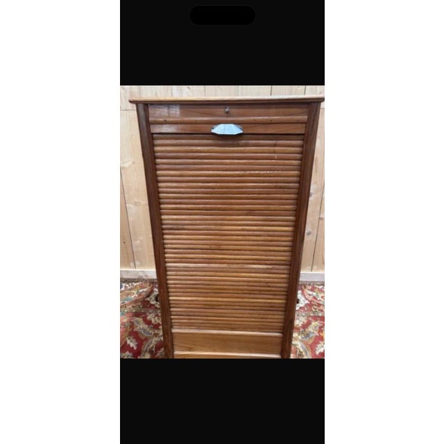 Elegant modernist-style tambour door filing cabinet dating from the 1950s-1960s, combining functionality with clean...