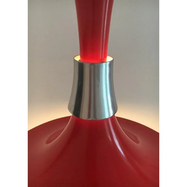 Lyska pendant lamp in red and chrome after a draft of Bent Nordsted from the 70s. The elegant shape of the luminaire...