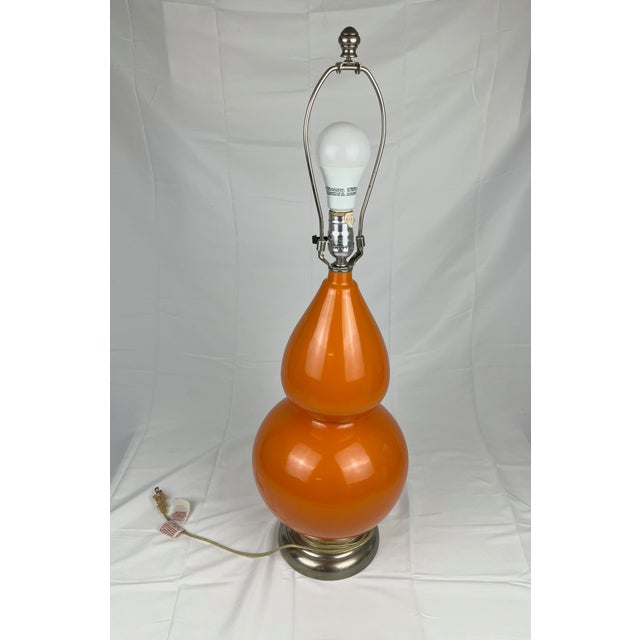 A perfect Hermès orange mid-century modern table lamp. Functional light with US plug. Does not come with shade.