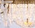 French antique crystal chandelier from the 1880s with decorative bronze detailing and numerous prisms. The chandelier has...