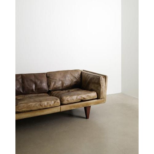 A rare danish mid century three seater sofa model "v11" with a thick original and patinated brown leather with beautifully...