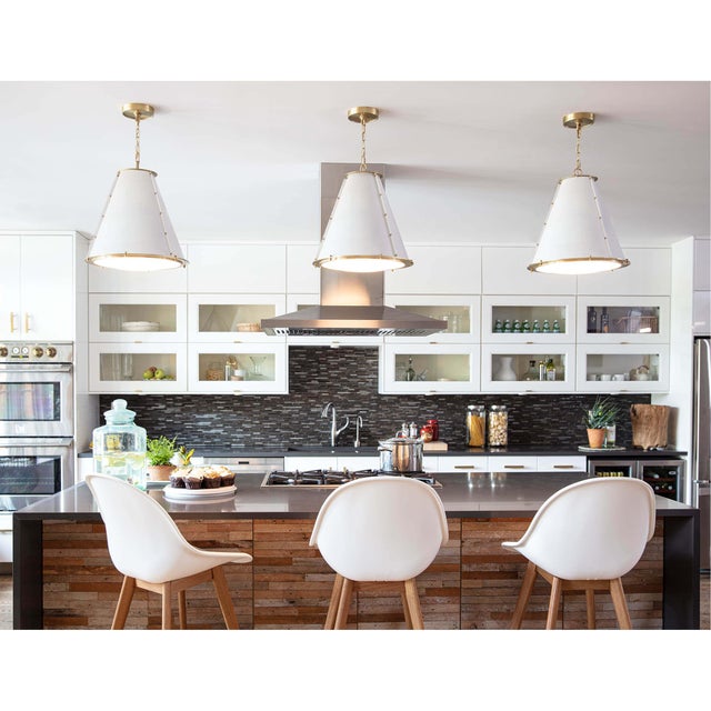 Bright and white, the French Maid chandelier has a simple cone silhouette that’s trimmed with natural brass detailing for...