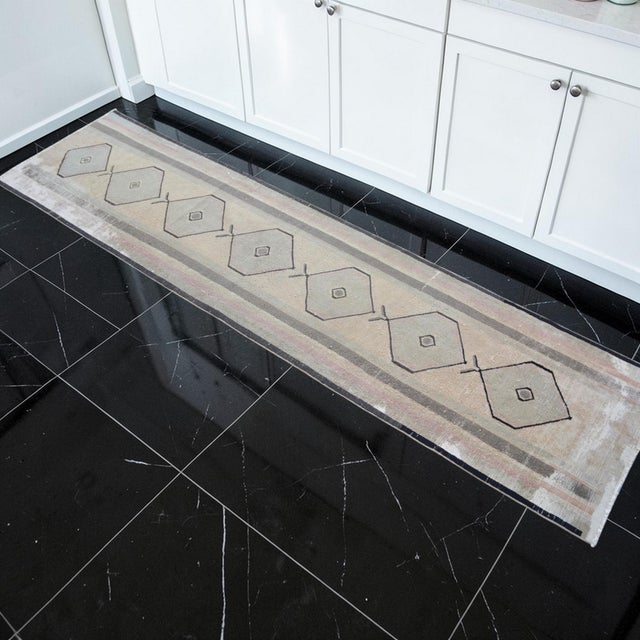 This mid-century hand-knotted runner originates from the weaving heart of Eastern Anatolia, capturing the rustic elegance...