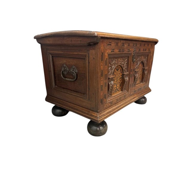 The extremely small coffer with 2 arched panels. The entire front with floral inlay of black stained pear and birch wood....