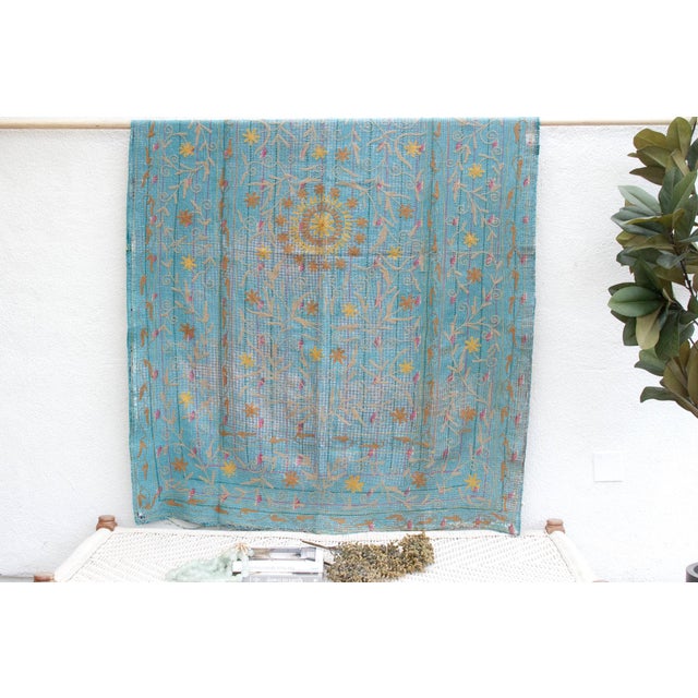 Charming vintage Turquoise Gold Suzani Floral Throw. The soft turquoise base provides a serene backdrop for the intricate...
