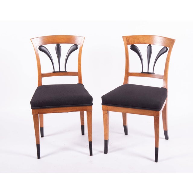 Pair of vintage (semi antique) Biedermeier Style Side Chairs. Curved headrail above ebonized fan form back splats above a...