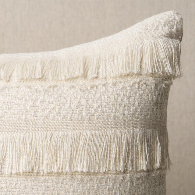 This pillow features Acadia with a knife edge finish. A horizontal fringed stripe, this pattern derives from a textile in...