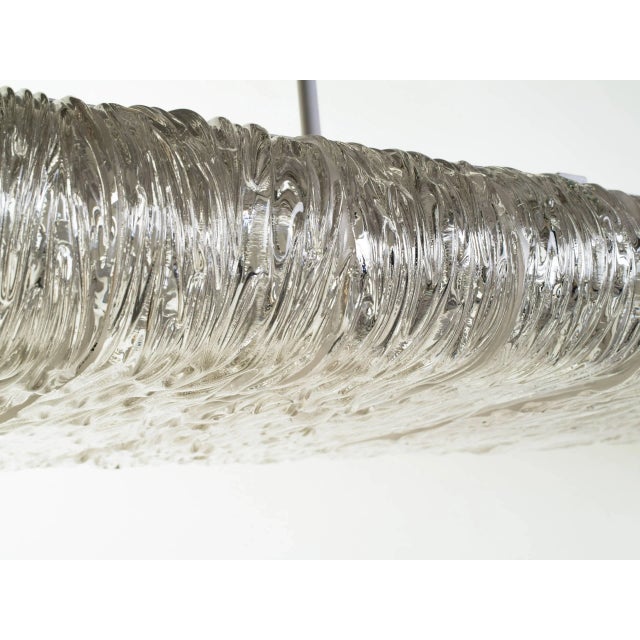 Chandelier composed of 14 textured glass slabs, solid brass end covers and steel frame. Two chandeliers available....