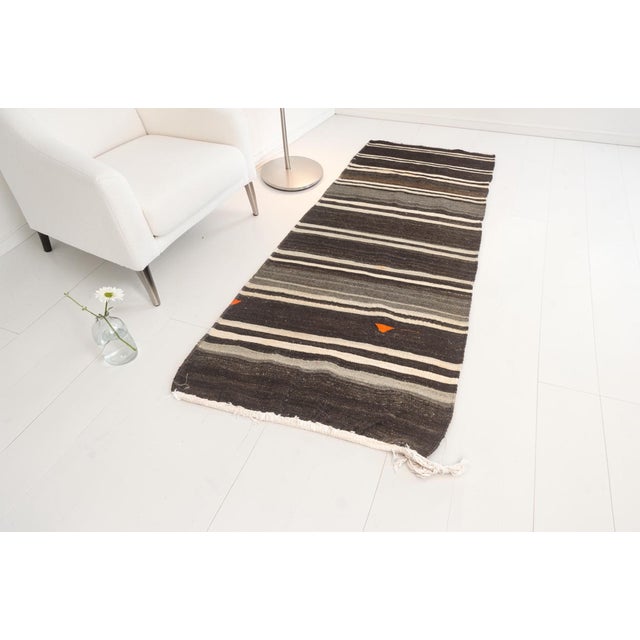 This is a vintage Turkish Oushak rug from the Mid 20th Century. The piece was hand-knotted.