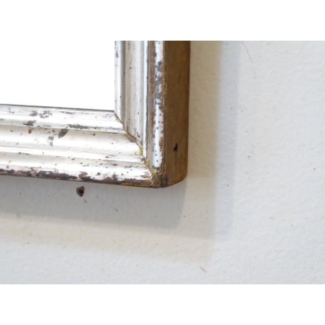 This small silver mirror measures 16.5'H x 13.5"W.