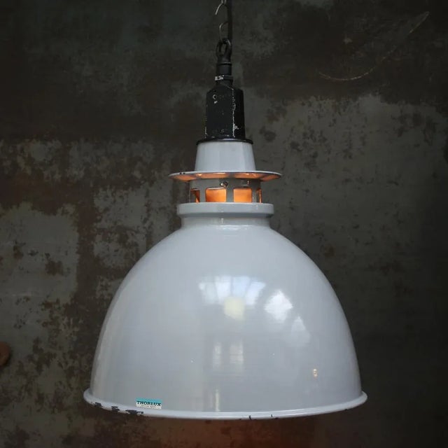 British vintage industrial pendant light by thorlux grey enamel with white interior. black metal top e27 / e26 this piece...