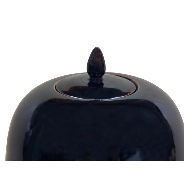 This elegant, deep black monochrome ceramic jar showcases a timeless, minimalist silhouette with a high-gloss glaze that...