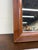 This is an elegant vintage traditional wall mirror featuring a richly toned cherry finish with stepped molded frame...