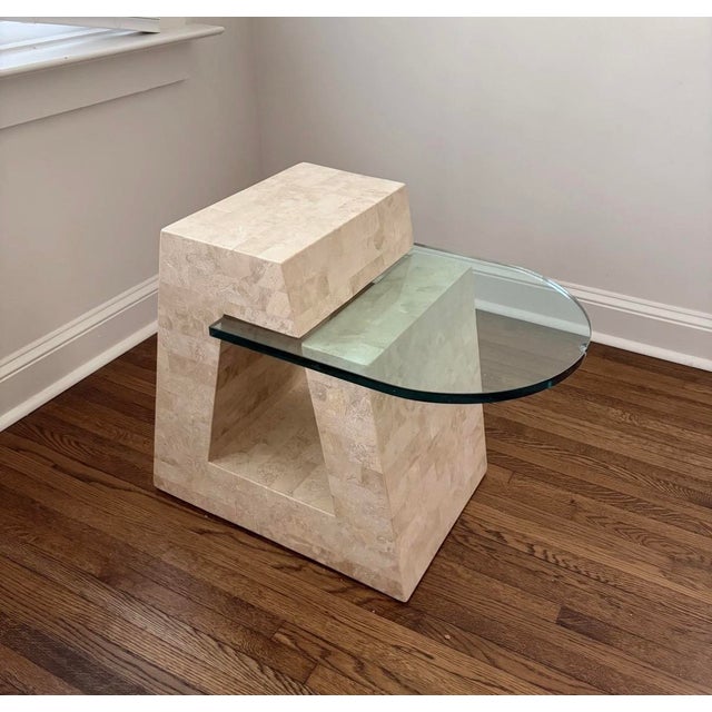 Striking 1980s postmodern side table with a sculpted tessellated Mactan fossil stone base in warm cream and an asymmetric...