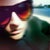 Reflection is a captivating contemporary portrait of a figure wearing sunglasses, rendered with a dynamic blur that evokes...