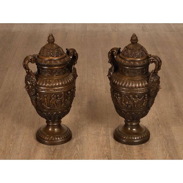 High Quality Pair Of Cast Bronze Urns Featuring Classical Form With Domed Lids And Finials. Bodies Are Decorated With...