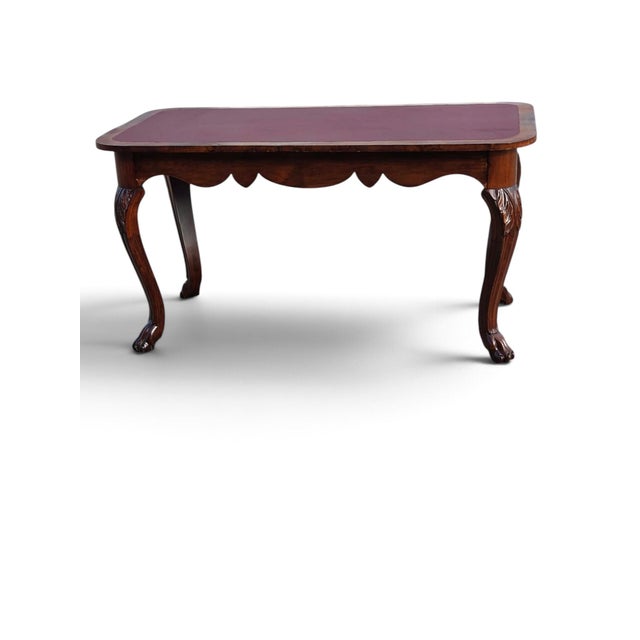 This 19th century American walnut center/desk/parlor table with a reddish brown leather top is a fully assembled antique...
